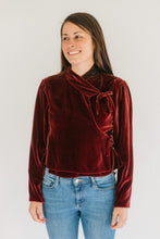 Load image into Gallery viewer, Woman in red velvet Nepali Top. Wearing jeans standing in front of white background.
