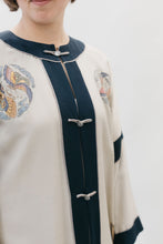 Load image into Gallery viewer, Close up photo of view C neckline and front closure.  Decorative designs are seen on both front panels.
