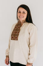 Load image into Gallery viewer, Woman wearing View B with embroidered neck opening and sleeve cuffs.  Shirt is unbuttoned to show side neck opening.
