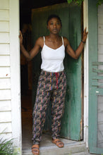 Load image into Gallery viewer, Young African American woman standing in a doorway wearing 119 Sarouelle pants view B (African Pants)
