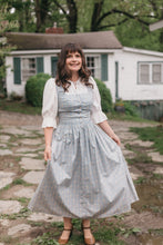 Load image into Gallery viewer, Woman walking on stone path wearing Dirndl View A.  Dress is light blue.
