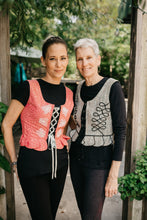 Load image into Gallery viewer, Two women standing side by side outdoors in Polish Vests.
