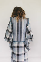 Load image into Gallery viewer, Girl wearing a plaid kimono-style garment against a white background
