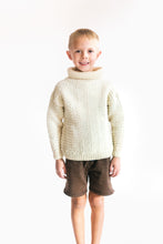 Load image into Gallery viewer, Small boy wearing a cream colored knitted sweater standing in front of a white screen

