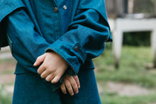 Load image into Gallery viewer, Young girl wearing a blue Australian Drovers Coat.  Close up view of sleeves
