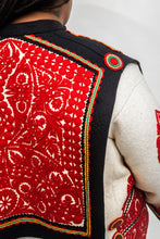 Load image into Gallery viewer, Close up back view of the cut felt work of the Szur. White and black szur with red felt work
