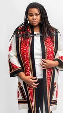Load image into Gallery viewer, Black woman standing in a traditional szur that is white, black and red wool felt with cutwork applique..
