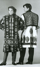 Load image into Gallery viewer, Black and white photo of an man and woman standing side by side in two versions of the Szur.  Woman is facing forward and wears view B (contemporary) man's back is facing the camera and is wearing view A (traditional) szur.
