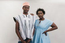 Load image into Gallery viewer, An African American young man and women standing in front of a white studio backdrop wearing the Ghanaian Smock.
