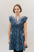 Load image into Gallery viewer, young brunette white woman standing in front of a white studio backdrop wearing the Ghanaian Smock.
