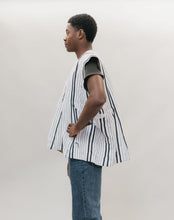 Load image into Gallery viewer, side view of Young African American man standing in front of a white studio backdrop wearing the men's Ghanaian Smock
