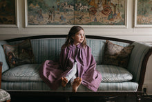 Load image into Gallery viewer, Little girl sitting on a sofa in a room wearing 208 Kinsale Cloak for young Maidens.
