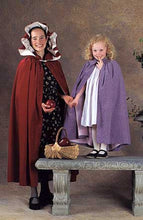 Load image into Gallery viewer, A young women standing holding a red apple and a little girl standing on a stone bench with a basket full of apples both wearing 208 Kinsale Cloak for Young Maidens.
