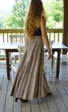 Load image into Gallery viewer, Back view of young red head woman walking in front of a dinning room table outside on a porch wearing black spaghetti strapped top wearing 209 Walking Skirt.
