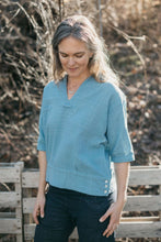 Load image into Gallery viewer, A white woman standing outside looking down wearing the 211 Two Middies v-neck
