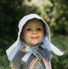 Load image into Gallery viewer, Little girl surrounded by greenery wearing 213 Sunbonnet.
