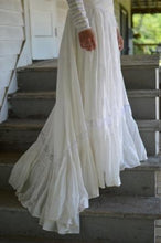 Load image into Gallery viewer, Close up of Woman standing on a stair case displaying the 227 Edwardian Bridal Gown and Dress full sweep of skirt.
