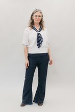 Load image into Gallery viewer, Woman smiling and standing in front of a white studio backdrop wearing 229 Sailor pants and 211 Two middies with scarf.
