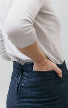 Load image into Gallery viewer, back side view of 229 Sailor Pants with hand in the welt pocket, and the laced up back.
