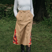 Load image into Gallery viewer, Close up of woman walking surrounded by greenery 231 Big Sky Riding Skirt buttoned to the left for a skirt effect
