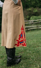 Load image into Gallery viewer, Close up back view of a woman wearing 231 Big Sky Riding Skirt and black boots surrounded by greenery.
