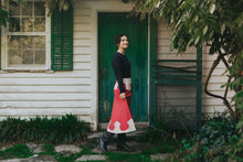 Load image into Gallery viewer, young brunette white woman walking towards the right in front of a house surrounded by greenery wearing 243 Rodeo Cowgirl Skirt
