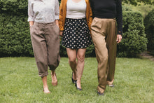 Load image into Gallery viewer, three women walking surrounded by greenery one wearing the trousers, shorts and pants from 250 Hollywood Pants

