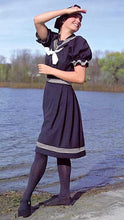 Load image into Gallery viewer, Young brunette white woman standing by a lake shading her face with her hand wearing the 253 Vintage Bathing Costume.

