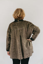 Load image into Gallery viewer, Back view of woman wearing the hip length 254 Swing Coat with hand in her hip.
