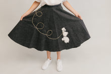 Load image into Gallery viewer, Close up of the At The Hop skirt fanned out with her hands,with poodle design
