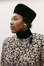 Load image into Gallery viewer, Close up of a Black woman wearing a brown and black coat with black velvet collar and turban hat.
