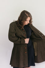 Load image into Gallery viewer, Brunette White woman wearing a black dress underneath the Countryside Frock Coat opening the left side of her jacket showing the inside.
