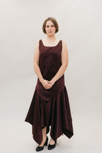 Load image into Gallery viewer, Young Burnett White woman with neck length hair, standing in front of a studio white backdrop wearing the #264 Monte Carlo Dress in maroon., with black pumps.
