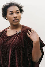 Load image into Gallery viewer, African American woman with short black hair gazing to the right with left hand on her shoulder wearing the Monte Carlo Dress V-neck Tunic
