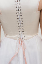 Load image into Gallery viewer, Back view of square neck Lady's Corset laced in the back in white. Pink ribbons show on a slip chemise
