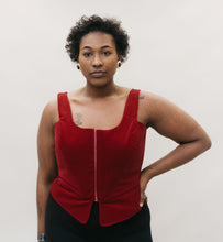 Load image into Gallery viewer, African American woman wearing the Lady's Corset scoop neck in red, left hand on her hip standing in front of a studio white backdrop.
