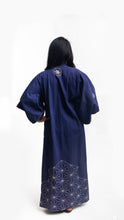 Load image into Gallery viewer, Asian American woman wearing a navy embroidered kimono standing in front of a white background. Back view with sashiko embroidery.
