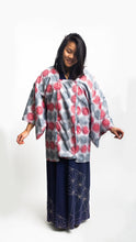 Load image into Gallery viewer, Woman wearing a red and grey spiral printed ankara fabric made into a Michiyuki over a blue cotton kimono
