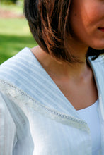 Load image into Gallery viewer, Close up of the collar of the Metro Middy Blouse in white with a lace trim.
