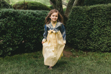 Load image into Gallery viewer, Young girl in action walking with han-bok held in hands.  Photo shows movement of dress and drape in action.
