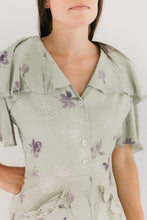 Load image into Gallery viewer, Close up photo of woman in light mint green and lavendar dress.  View B.  Shows the  button front closure and the flounced neckline. View B is more casual, with buttoned front, flounce collar and sleeves, and eyelash pockets.
