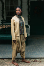 Load image into Gallery viewer, Person wearing a gold Algerian Suit with green vest outside.
