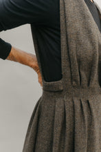 Load image into Gallery viewer, Woman standing with right arm on her back , wearing a black long sleeved underneath the jumper, close up of the armscyces open to just above the waist with pleats.
