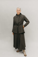 Load image into Gallery viewer, Older white woman smiling, standing her left hand on her hip, in front of a studio white backdrop wearing the 508 traveling suit buttoned
