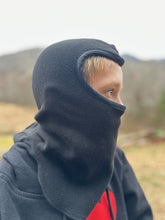 Load image into Gallery viewer, Side view of boy wearing a black fleece balaclava outside
