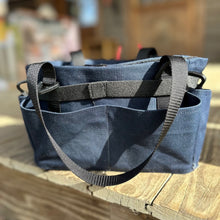 Load image into Gallery viewer, Navy blue tool caddy with straps on a wooden deck
