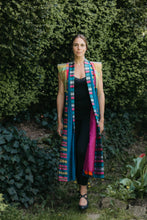 Load image into Gallery viewer, Woman walking outside wearing multi colored Tibetan panel coat
