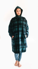 Load image into Gallery viewer, Photo of young woman wearing parka with hood pulled up.  hands are in both pockets and she looks forward towards the camera.
