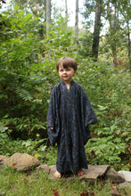 Load image into Gallery viewer, Boy wearing a dark blue kimono standing in a forest
