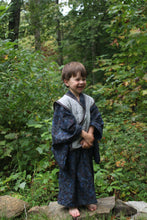 Load image into Gallery viewer, Child in a forest wearing a dark kimono coat with a grey vest
